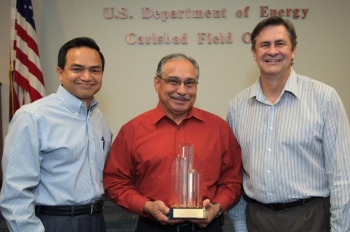 Department of Energy Carlsbad Field Site Operations Director Casey  Gadbury (right) and Farok Sharif, President and Project Manager for Nuclear Waste Partnership 
LLC, the management and operating contractor at the Waste Isolation Pilot Plant, present the  DOE's Voluntary Protection Program Legacy Star Award to Richard De Los Santos, protective force manager for Security Walls, the security contractor at the Waste Isolation Pilot Plant. The DOE-VPP legacy star award is the highest level of recognition possible in the VPP.