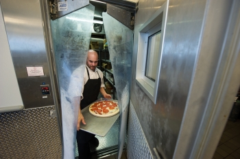 Dale Linkous carries pizza out of the walk-in freezer in the kitchen at the National Renewable Energy Laboratory in Golden, Colorado. The Energy Department <a href="http://energy.gov/articles/new-energy-efficiency-standards-commercial-refrigeration-equipment-cut-businesses-energy">announced new energy efficiency standards</a> for commercial freezers and refrigerators. | Photo by Dennis Schroeder, National Renewable Energy Laboratory Dale Linkous carries pizza out of the walk-in freezer in the kitchen at the National Renewable Energy Laboratory in Golden, Colorado. The Energy Department <a href="http://energy.gov/articles/new-energy-efficiency-standards-commercial-refrigeration-equipment-cut-businesses-energy">announced new energy efficiency standards</a> for commercial freezers and refrigerators. | Photo by Dennis Schroeder, National Renewable Energy Laboratory