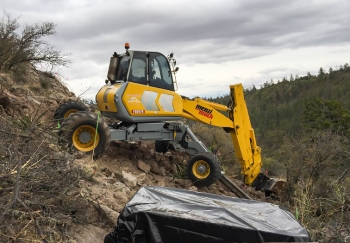 A spider excavator extracts mercury-contaminated soil. A spider excavator extracts mercury-contaminated soil.
