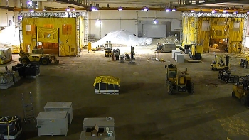 At one time more than 150,000 drums and boxes of transuranic waste were stored in the Transuranic Storage Area-Retrieval Enclosure. Now, with those containers safely retrieved, all that remains is the equipment and structures used to finish their retrieval, including the two yellow Inner Contamination Enclosures that were placed over severely degraded containers, adding another level of containment during retrieval. At one time more than 150,000 drums and boxes of transuranic waste were stored in the Transuranic Storage Area-Retrieval Enclosure. Now, with those containers safely retrieved, all that remains is the equipment and structures used to finish their retrieval, including the two yellow Inner Contamination Enclosures that were placed over severely degraded containers, adding another level of containment during retrieval.