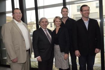During his trip to Austin, Texas, on February 6, 2014, Energy Secretary Ernest Moniz toured the Pecan Street Research Institute's Pike Powers Lab, a UT-Austin-affiliated facility with specialized capabilities for developing, testing and validating a wide range of smart grid, distributed energy and consumer electronics hardware and software. Pictured left to right: Pecan Street data group director Grant Fisher; Secretary Moniz; Pecan Street Chief Operating Officer Suzanne Russo; Pecan Street Chief Technology Officer Bert Haskell; and Scott Hinson, Director of the Pike Powers Laboratory and Center for Commercialization. | Photo by Marsha Miller, University of Texas at Austin. During his trip to Austin, Texas, on February 6, 2014, Energy Secretary Ernest Moniz toured the Pecan Street Research Institute's Pike Powers Lab, a UT-Austin-affiliated facility with specialized capabilities for developing, testing and validating a wide range of smart grid, distributed energy and consumer electronics hardware and software. Pictured left to right: Pecan Street data group director Grant Fisher; Secretary Moniz; Pecan Street Chief Operating Officer Suzanne Russo; Pecan Street Chief Technology Officer Bert Haskell; and Scott Hinson, Director of the Pike Powers Laboratory and Center for Commercialization. | Photo by Marsha Miller, University of Texas at Austin.