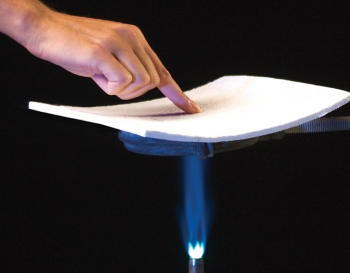 Aspen Aerogel's innovative insulation material works well under very cold and very hot temperatures. Here, the insulation is held over a flame. | Courtesy of Aspen Aerogels. Aspen Aerogel's innovative insulation material works well under very cold and very hot temperatures. Here, the insulation is held over a flame. | Courtesy of Aspen Aerogels.