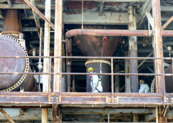 Workers clean 5,700 feet of piping on Alpha-4âs west side. Workers clean 5,700 feet of piping on Alpha-4âs west side.