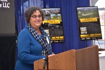 EM Principal Deputy Assistant Secretary Sue Cange speaks at the reindustrialization programâs 20th anniversary event. EM Principal Deputy Assistant Secretary Sue Cange speaks at the reindustrialization programâs 20th anniversary event.