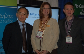 Secretary Steven Chu with Kellie Walsh and Cris Dorman of Greater Indiana Clean Cities at the Green Truck Summit in Indianapolis, IN, in front of a display describing the coalition's Recovery Act-supported project. | Photo by Trish Cozart, NREL. Secretary Steven Chu with Kellie Walsh and Cris Dorman of Greater Indiana Clean Cities at the Green Truck Summit in Indianapolis, IN, in front of a display describing the coalition's Recovery Act-supported project. | Photo by Trish Cozart, NREL.