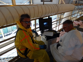 Frank Carney from Manta Robotics (left) and Kirk Barlow, BWCS systems engineering manager, use a monitor to see inside the tank. Frank Carney from Manta Robotics (left) and Kirk Barlow, BWCS systems engineering manager, use a monitor to see inside the tank.