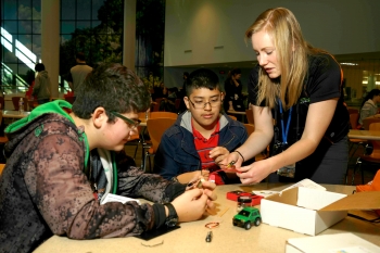 Tori Hawn, communications manager for the Colorado State University team, is showing two of the middle schoolers at Education Day how to put together a regenerative braking kit. Regenerative braking is used in hybrid electric vehicles to capture and reuse energy from the brakes that would be otherwise lost. Tori Hawn, communications manager for the Colorado State University team, is showing two of the middle schoolers at Education Day how to put together a regenerative braking kit. Regenerative braking is used in hybrid electric vehicles to capture and reuse energy from the brakes that would be otherwise lost.