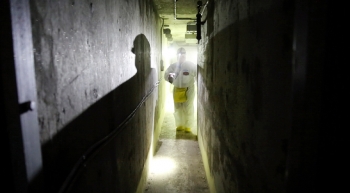 A radiation control technician surveys the radiation levels in the basement level of the F Reactor. A radiation control technician surveys the radiation levels in the basement level of the F Reactor.