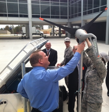 Air Force Academy staff and cadets showing FEMP directors the technical highlights of a trailer designed to collect and store solar and wind energy to power an electric expeditionary vehicle indefinitely. Photo Courtesy | Oak Ridge National Laboratory Air Force Academy staff and cadets showing FEMP directors the technical highlights of a trailer designed to collect and store solar and wind energy to power an electric expeditionary vehicle indefinitely. Photo Courtesy | Oak Ridge National Laboratory