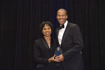 Director Dot Harris presents Chris Smith, Principal Deputy Assistant Secretary and Acting Assistant Secretary of Fossil Energy, with a professional achievement award at the Black Engineer of the Year Awards conference this February. Photo Credit: Nancy Jo Brown/106FOTO Director Dot Harris presents Chris Smith, Principal Deputy Assistant Secretary and Acting Assistant Secretary of Fossil Energy, with a professional achievement award at the Black Engineer of the Year Awards conference this February. Photo Credit: Nancy Jo Brown/106FOTO