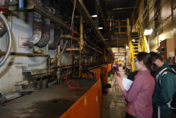 Sandina Ponte, a member of the University of Missouri's Industrial Assessment Center, inspects equipment at a manufacturing facility during an energy audit. | Photo courtesy of University of Missouri IAC. Sandina Ponte, a member of the University of Missouri's Industrial Assessment Center, inspects equipment at a manufacturing facility during an energy audit. | Photo courtesy of University of Missouri IAC.