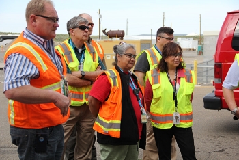 Shirley Perez, a robotic arms operator, center, and EM Assistant Secretary Monica Regalbuto, right, listen to a briefing on the new robotic arms to be installed in EMâs Advanced Mixed Waste Treatment Project this fall. Shirley Perez, a robotic arms operator, center, and EM Assistant Secretary Monica Regalbuto, right, listen to a briefing on the new robotic arms to be installed in EMâs Advanced Mixed Waste Treatment Project this fall.