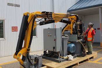 AMWTP employee Shirley Perez checks out features of new robotic arms to be installed this fall to help with legacy waste cleanup. AMWTP employee Shirley Perez checks out features of new robotic arms to be installed this fall to help with legacy waste cleanup.