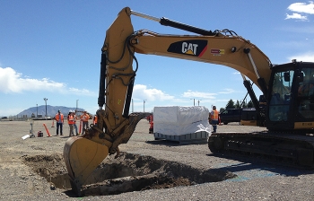 Workers excavate contaminated material at the French drains site. Workers excavate contaminated material at the French drains site.