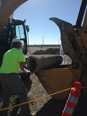 Employees collect samples from the bottom section of the drain pipe. Employees collect samples from the bottom section of the drain pipe.