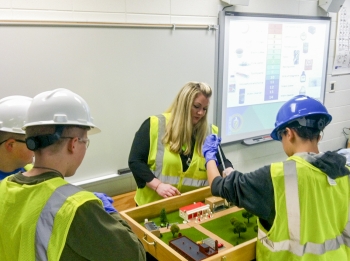Elizabeth Wyatt, mechanical engineer and senior technical advisor for Fluor Paducah Deactivation Project, helps Ballard County Middle School students understand groundwater and water sampling. Elizabeth Wyatt, mechanical engineer and senior technical advisor for Fluor Paducah Deactivation Project, helps Ballard County Middle School students understand groundwater and water sampling.