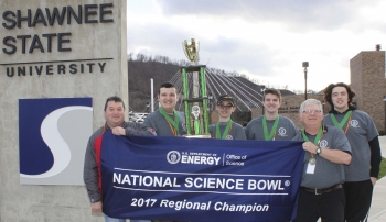 The winning Science Bowl team from Wheelersburg High School displays their victory banner immediately following the South Central Ohio Regional competition. Pictured (left to right) are: DOE Regional Coordinator Greg Simonton, team captain Jacob Lewis, Gus Shoemaker, Aaron Bundy, coach Paul Boll, and Quin Whitley. The winning Science Bowl team from Wheelersburg High School displays their victory banner immediately following the South Central Ohio Regional competition. Pictured (left to right) are: DOE Regional Coordinator Greg Simonton, team captain Jacob Lewis, Gus Shoemaker, Aaron Bundy, coach Paul Boll, and Quin Whitley.
