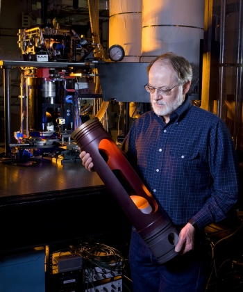 Sandia researcher John Dec holds a specialized optical piston used in engine research at the Combustion Research Facility. | Photo courtesy of Randy Wong, Sandia National Laboratories. Sandia researcher John Dec holds a specialized optical piston used in engine research at the Combustion Research Facility. | Photo courtesy of Randy Wong, Sandia National Laboratories.