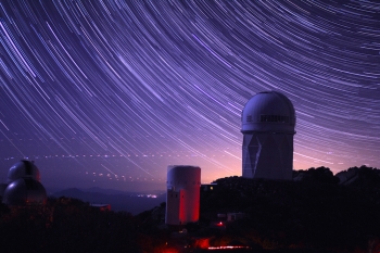 Star trails take shape around Kitt Peak National Observatory in this long-exposure image. The 4-meter Mayall telescope building, at right, now houses Mosaic-3, a new infrared camera built by a collaboration that includes Berkeley Lab scientists. | Photo credit: P. Marenfeld and NOAO/AURA/NSF. Star trails take shape around Kitt Peak National Observatory in this long-exposure image. The 4-meter Mayall telescope building, at right, now houses Mosaic-3, a new infrared camera built by a collaboration that includes Berkeley Lab scientists. | Photo credit: P. Marenfeld and NOAO/AURA/NSF.