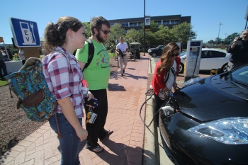 UNC Pembroke students look on as Ashley Fiala demonstrates how to charge a PEV. | Photo courtesy of Willis Glassgow, Campus Photographer, UNC Pembroke UNC Pembroke students look on as Ashley Fiala demonstrates how to charge a PEV. | Photo courtesy of Willis Glassgow, Campus Photographer, UNC Pembroke
