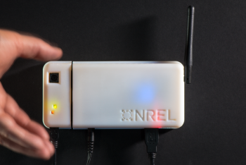 Researchers at the Energy Department's National Renewable Energy Laboratory recently developed a new smart occupancy sensor that adds optics to what had only been a motion detection before. The new sensor combines an inexpensive camera with a high-speed microprocessor and algorithms to detect movement and human presence in a room with an accuracy of more than 90 percent -- an advancement that could lead to enormous energy savings in commercial buildings. | Photo courtesy of Dennis Schroeder, NREL. Researchers at the Energy Department's National Renewable Energy Laboratory recently developed a new smart occupancy sensor that adds optics to what had only been a motion detection before. The new sensor combines an inexpensive camera with a high-speed microprocessor and algorithms to detect movement and human presence in a room with an accuracy of more than 90 percent -- an advancement that could lead to enormous energy savings in commercial buildings. | Photo courtesy of Dennis Schroeder, NREL.