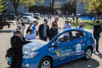 This hybrid electric Prius that was on display at the National Alternative Fuels Day Odyssey kick-off event has been specially modified for training purposes. With this "cut-away" vehicle, mechanics and other students learning about hybrid electric vehicles can see the inside of the car and better understand how it is different from a conventional gasoline vehicle. This hybrid electric Prius that was on display at the National Alternative Fuels Day Odyssey kick-off event has been specially modified for training purposes. With this "cut-away" vehicle, mechanics and other students learning about hybrid electric vehicles can see the inside of the car and better understand how it is different from a conventional gasoline vehicle.
