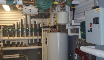 Geothermal and solar hot water heater control room at AHAâs Sunrise Acres Complex. Photo from Akwesasne Housing Authority Geothermal and solar hot water heater control room at AHAâs Sunrise Acres Complex. Photo from Akwesasne Housing Authority