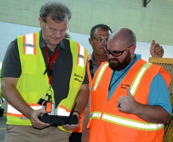 Fluor-BWXT Site Project Director Dennis Carr, left, learns how to operate a FirstLook robot from Fluor-BWXT Nondestructive Assay Engineer Kevin Banks. Fluor-BWXT Site Project Director Dennis Carr, left, learns how to operate a FirstLook robot from Fluor-BWXT Nondestructive Assay Engineer Kevin Banks.