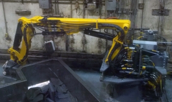 A newly installed robotic arm is at work. A newly installed robotic arm is at work.