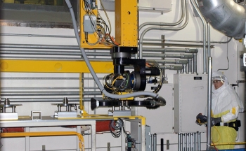 A maintenance technician works with the new box-opening gantry robot system. A maintenance technician works with the new box-opening gantry robot system.