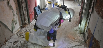A worker takes a sample from a concrete floor. A worker takes a sample from a concrete floor.