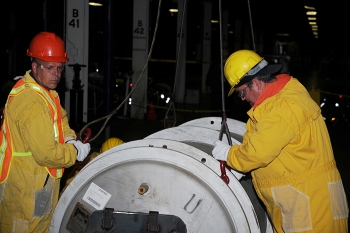 Workers in the X-326 building package a component for shipment. Workers in the X-326 building package a component for shipment.