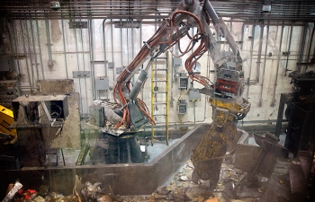 A robotic arm sorts contaminated materials in an AMWTP boxline. A robotic arm sorts contaminated materials in an AMWTP boxline.