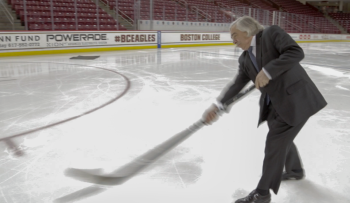 Energy Secretary Ernest Moniz takes a slap shot at Boston College's Conte Forum to promote green sports arenas. | Photo by Simon Edelman, Energy Department. Energy Secretary Ernest Moniz takes a slap shot at Boston College's Conte Forum to promote green sports arenas. | Photo by Simon Edelman, Energy Department.