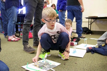 A determined young participant in the Museum of Idaho â Fluor Idaho Engineering Day puts his newly designed catapult to the test. A determined young participant in the Museum of Idaho â Fluor Idaho Engineering Day puts his newly designed catapult to the test.