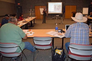 Representatives from the Consolidated Group of Tribes and Organizations listen and take notes during Nevada Field Office EM presentations. Representatives from the Consolidated Group of Tribes and Organizations listen and take notes during Nevada Field Office EM presentations.