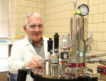 Dr. Vitalij Pecharsky in his research facility at Ames Laboratory, working with a calorimeter. <em>Photo courtesy of Ames Laboratory. </em> Dr. Vitalij Pecharsky in his research facility at Ames Laboratory, working with a calorimeter. <em>Photo courtesy of Ames Laboratory. </em>