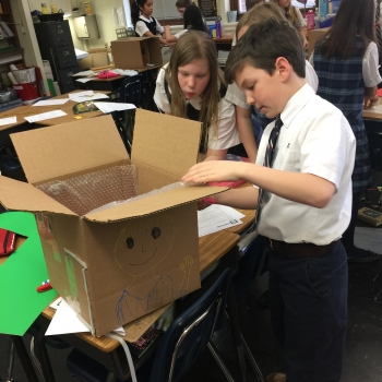 Students at St. Agnus Catholic School in Arlington, Va., measure weatherstripping to place around doors and windows Students at St. Agnus Catholic School in Arlington, Va., measure weatherstripping to place around doors and windows