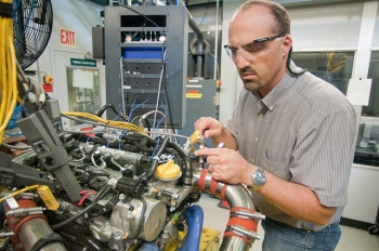 Argonne engineer Steve Ciatti works on an engine in Argonne's Engine Research Facility -- a facility where researchers can study in-cylinder combustion and emissions under realistic operating conditions. | Photo courtesy of Argonne National Laboratory. Argonne engineer Steve Ciatti works on an engine in Argonne's Engine Research Facility -- a facility where researchers can study in-cylinder combustion and emissions under realistic operating conditions. | Photo courtesy of Argonne National Laboratory.