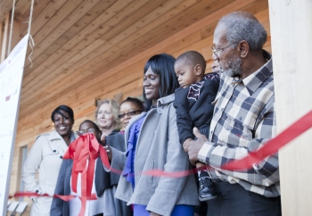 One of the new homeowners, Layika Culley, and her family cut the ribbon to her new ultra-efficient home in the historic Deanwood neighborhood. For more photos of the Empowerhouse ribbon cutting, <a href="/node/580963">view our photo gallery</a>. | Photo courtesy of Sarah Gerrity, Energy Department. One of the new homeowners, Layika Culley, and her family cut the ribbon to her new ultra-efficient home in the historic Deanwood neighborhood. For more photos of the Empowerhouse ribbon cutting, <a href="/node/580963">view our photo gallery</a>. | Photo courtesy of Sarah Gerrity, Energy Department.