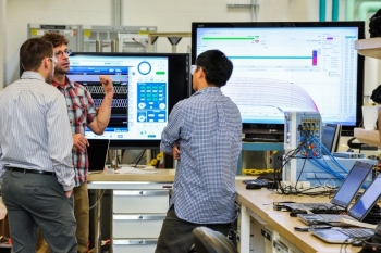 National Renewable Energy Laboratory engineer Greg Martin (from left) works with Solectria engineers Jonathon Smith and Jihua Ma testing Solectria's smart inverter at the Energy Systems Integration Facility in Golden, Colorado. | Photo by Dennis Schroeder, National Renewable Energy Laboratory National Renewable Energy Laboratory engineer Greg Martin (from left) works with Solectria engineers Jonathon Smith and Jihua Ma testing Solectria's smart inverter at the Energy Systems Integration Facility in Golden, Colorado. | Photo by Dennis Schroeder, National Renewable Energy Laboratory
