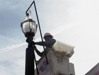 A worker installs energy-saving streetlights on Colorado Avenue. | Photo courtesy of Springs Sustainability A worker installs energy-saving streetlights on Colorado Avenue. | Photo courtesy of Springs Sustainability