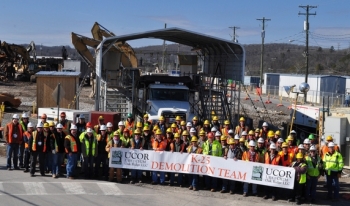 Employees with the K-25 demolition team gather for a photo following the completion of demolition of the north end of the K-25 Building today. Employees with the K-25 demolition team gather for a photo following the completion of demolition of the north end of the K-25 Building today.