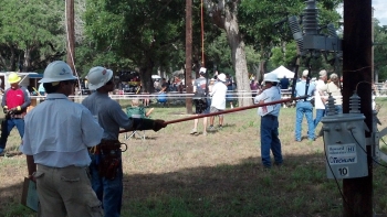 Line workers get hands-on experience with an electrical pole as part of their training. | Photo courtesy of David Weaver. Line workers get hands-on experience with an electrical pole as part of their training. | Photo courtesy of David Weaver.