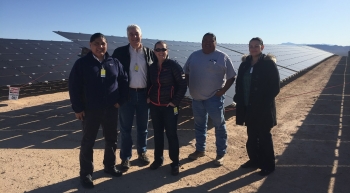 Touring First Solar's 250-megawatt Moapa Southern Paiute Solar Project located on the Moapa River Reservation. From left to right: Office of Indian Energy Director Chris Deschene, Office of Indian Energy Senior Policy Advisor Doug MacCourt, National Renewable Energy Laboratory Engineer Sherry Stout, Moapa Band of Paiutes Vice Chairman Greg Anderson, and Office of Indian Energy 48 Contiguous States Program Manager Sarai Geary. Photo from Sam Scucci, First Solar
Touring First Solar's 250-megawatt Moapa Southern Paiute Solar Project located on the Moapa River Reservation. From left to right: Office of Indian Energy Director Chris Deschene, Office of Indian Energy Senior Policy Advisor Doug MacCourt, National Renewable Energy Laboratory Engineer Sherry Stout, Moapa Band of Paiutes Vice Chairman Greg Anderson, and Office of Indian Energy 48 Contiguous States Program Manager Sarai Geary. Photo from Sam Scucci, First Solar