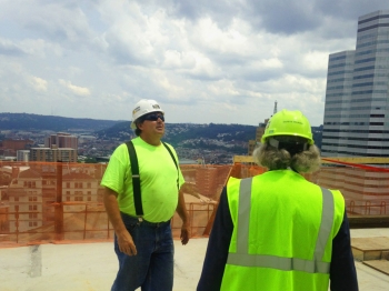 Century Steel Ironworker Al Williams escorts Secretary Moniz to the top floor of the construction site to show the work he and his team are completing during a visit to Pittsburgh on Monday, July 21, 2014. Century Steel Ironworker Al Williams escorts Secretary Moniz to the top floor of the construction site to show the work he and his team are completing during a visit to Pittsburgh on Monday, July 21, 2014.
