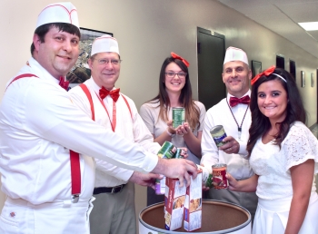 Oak Ridge Integrated Support Center employees Josh Clark (from left), Steve Martin, Katelynn Prutsman, Tom Rizzi and Hailey Beeler gave employees ice cream from a make-shift "ice cream truck" in exchange for non-perishable items. They even dressed the part! | Photo courtesy of Oak Ridge Integrated Support Center. Oak Ridge Integrated Support Center employees Josh Clark (from left), Steve Martin, Katelynn Prutsman, Tom Rizzi and Hailey Beeler gave employees ice cream from a make-shift "ice cream truck" in exchange for non-perishable items. They even dressed the part! | Photo courtesy of Oak Ridge Integrated Support Center.