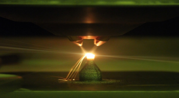 Green light reflection from a low-oxygen environment 3D printer laser deposition of metal powder alloys. Photo courtesy of The Critical Materials Institute, Ames Laboratory Green light reflection from a low-oxygen environment 3D printer laser deposition of metal powder alloys. Photo courtesy of The Critical Materials Institute, Ames Laboratory