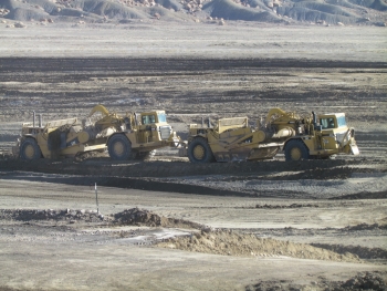 Two scrapers work together to excavate Mancos Shale at the Crescent Junction site to create the second portion of a disposal cell for uranium mill tailings Two scrapers work together to excavate Mancos Shale at the Crescent Junction site to create the second portion of a disposal cell for uranium mill tailings