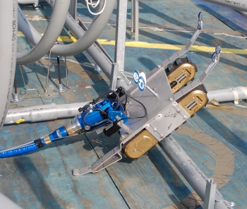 A robotic device named Tizzy was retrofitted by Savannah River Remediation (SRR) employees to collect and remove tank waste. Using $100,000 from the Recovery Act, SRR designed and built Tizzy. Here the robot is being tested on a mock-up of a waste tank A robotic device named Tizzy was retrofitted by Savannah River Remediation (SRR) employees to collect and remove tank waste. Using $100,000 from the Recovery Act, SRR designed and built Tizzy. Here the robot is being tested on a mock-up of a waste tank